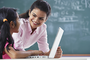 A tutor tutoring a girl on a laptop symbolizing home tuition for programming languages in delhi & ncr.